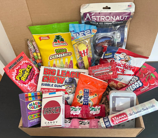 Assorted nostalgic candy and snacks gift box, including Pop Rocks, PEZ, gummies, and Big League Chew.