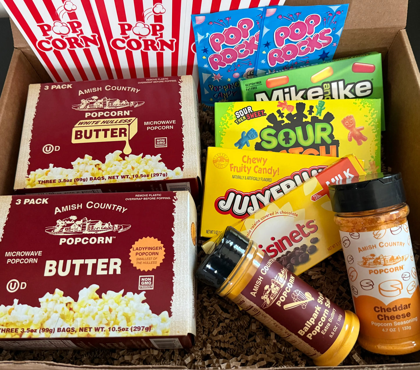 Gift box with Amish Country microwave popcorn, popcorn seasonings, candy, and snacks.