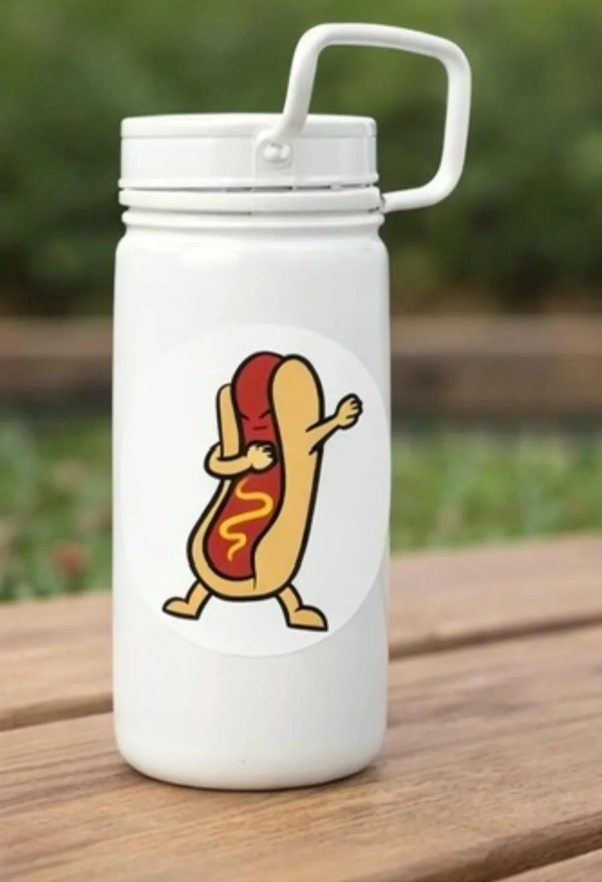 White water bottle with cartoon hot dog dabbing sticker, outdoor wood table view