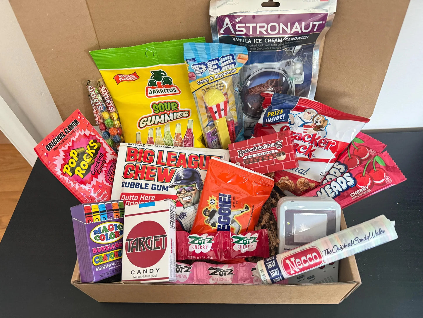 Assorted retro candy and snacks gift box with gummies, Pop Rocks, bubble gum, and treats.