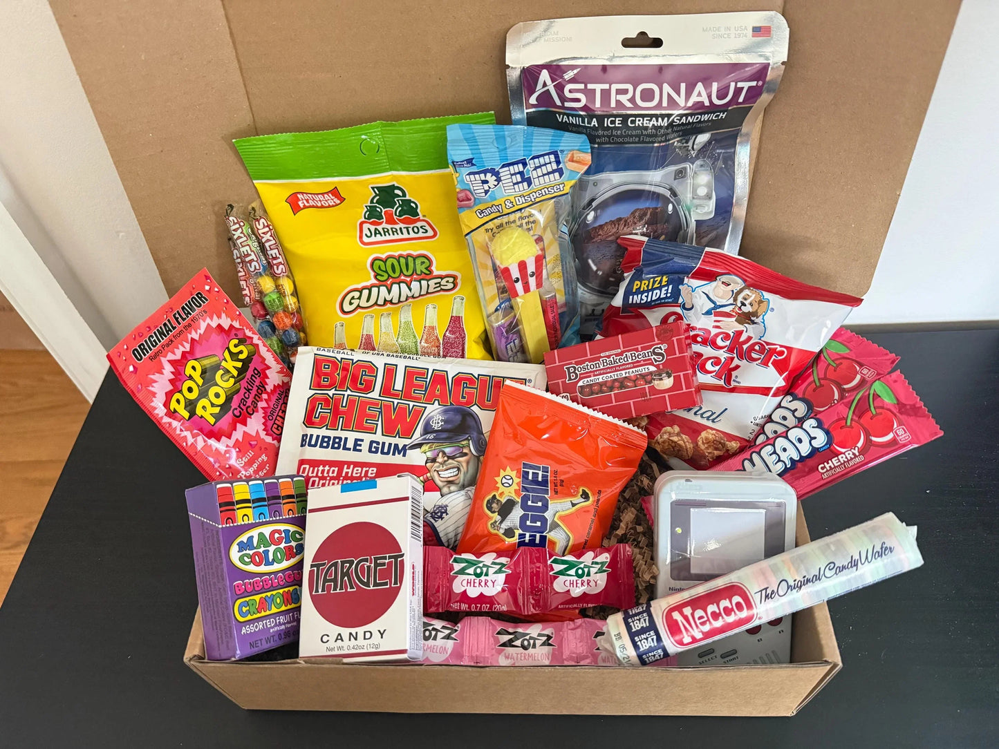Assorted retro candy and snacks gift box with Pop Rocks, Necco Wafers, and astronaut ice cream.