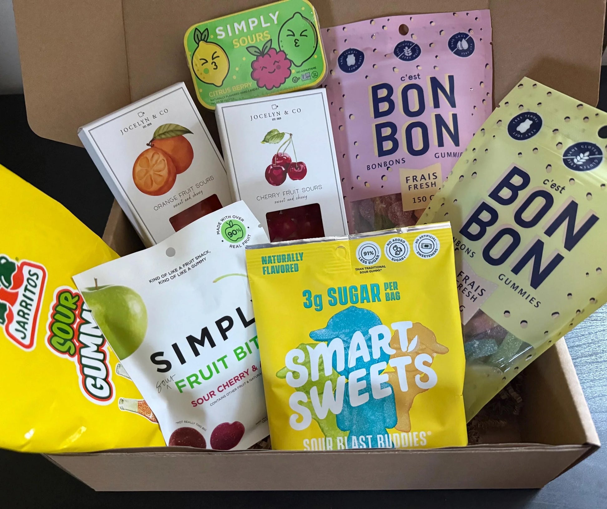 Assorted sour candy gift box with gummies, fruit sours, and artisan sweets