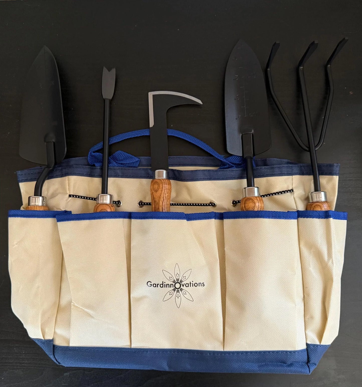 Canvas garden tool bag with wooden handle gardening tools in organized pockets