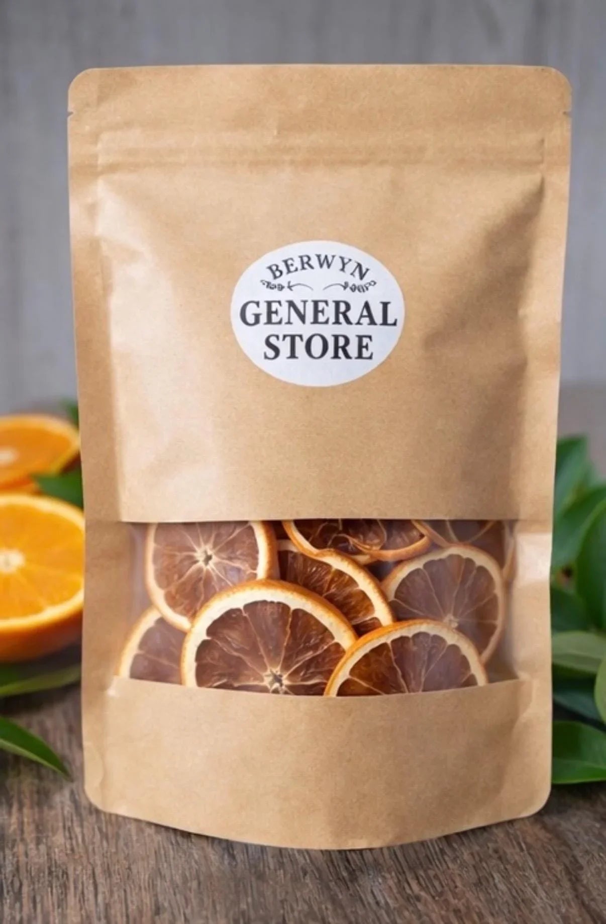 Bag of dried orange slices in kraft packaging, gourmet snack, on rustic wood table