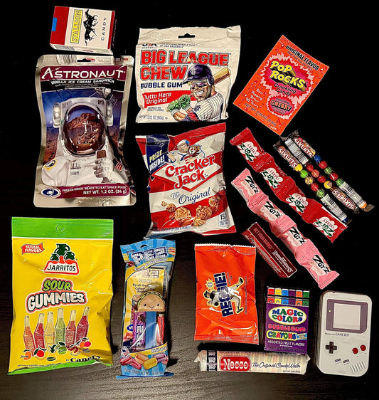 Assorted nostalgic candies and snacks including Pop Rocks, Big League Chew, Cracker Jack, Necco, and sour gummies displayed on a dark background.